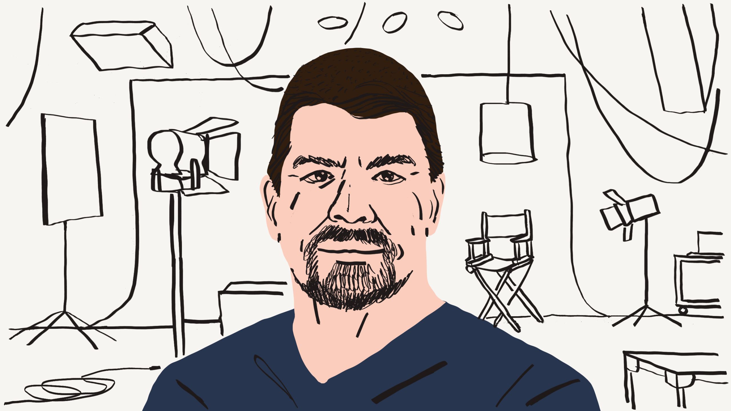 Person wearing a blue t-shirt in front of a film light and directors chair