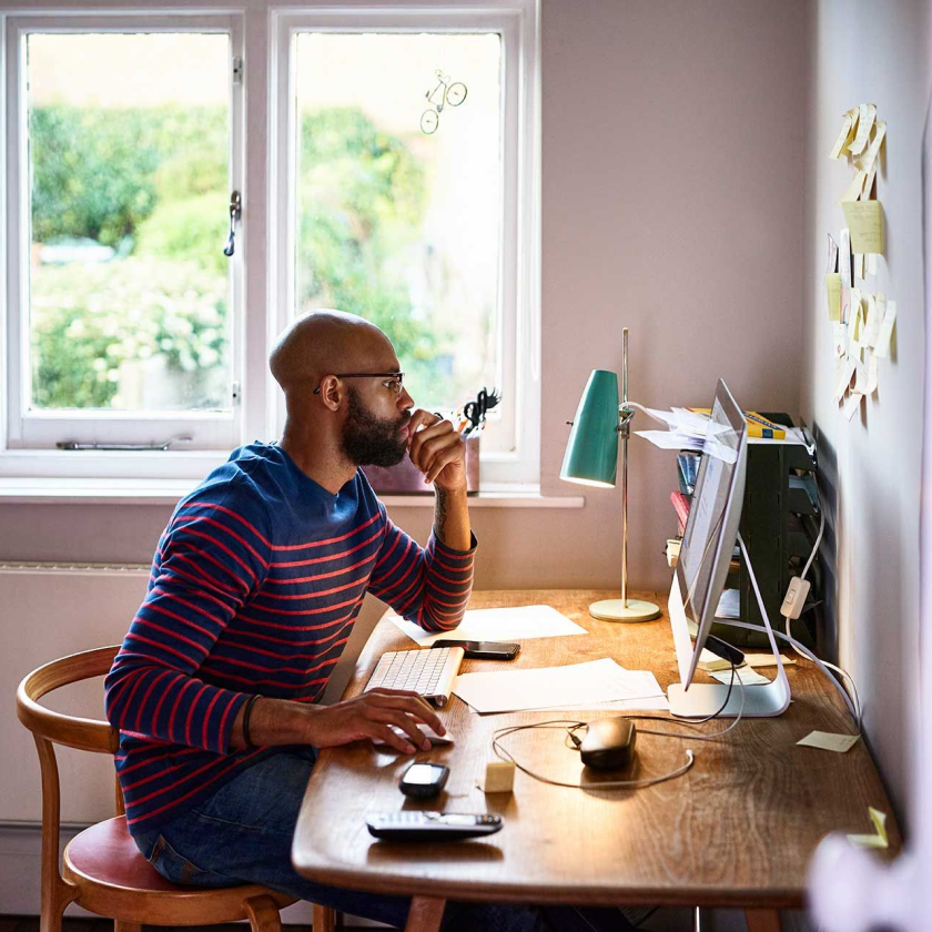 A person sits at their desk, looking frustrated that they can’t edit a PDF.
